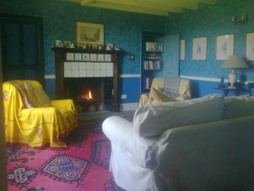 a living room with a couch and a fireplace at Barmoors in Lastingham