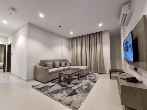 a living room with a couch and a tv at CENTRAL SALALAH in Salalah