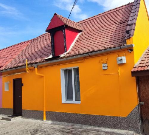 an orange house with a red roof at Andira Residence in Sibiu