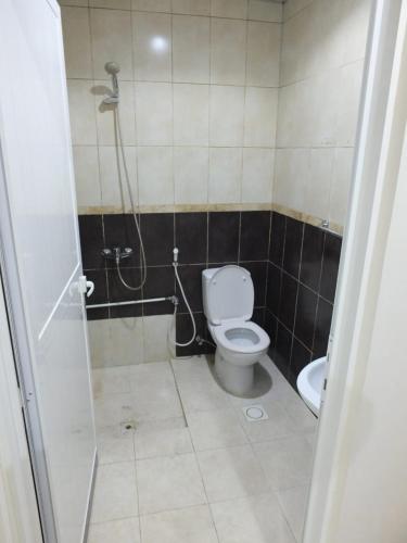 a bathroom with a toilet and a shower at DUBEDZ in Dubai