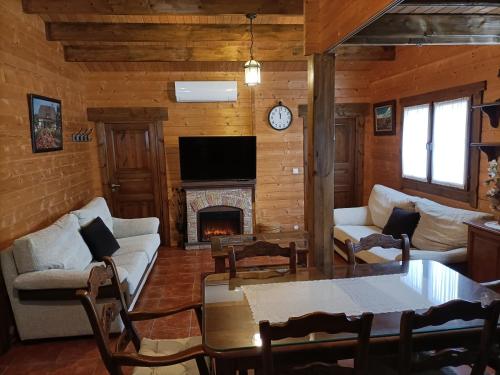 a living room with a couch and a fireplace at La Dehesa2 de Toledo in Cobisa