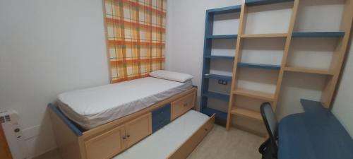 een kleine kamer met een stapelbed en een bureau bij Adosado con piscina y terraza a 700m de la playa in Gran Alacant