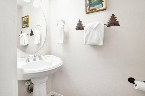 a white bathroom with a sink and a mirror at Apres Chalet Retreat~ Hot Tub~ Relax Away Cottage~ in Sugarloaf