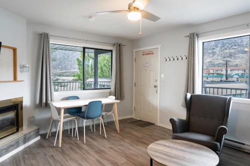 a living room with a table and chairs at Poplars Motel on the lake in Osoyoos