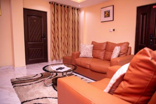 a living room with a couch and a table at Executive Two Bedroom Apartment in Accra in Accra