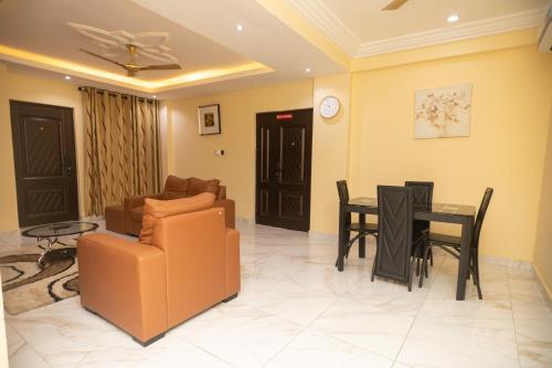 a living room with a couch and a table at Executive Two Bedroom Apartment in Accra in Accra