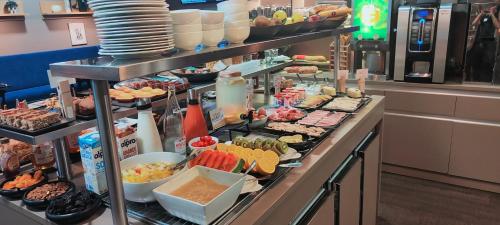 Una línea de buffet con muchos tipos diferentes de comida. en Mercure Périgueux Centre Historique, en Périgueux