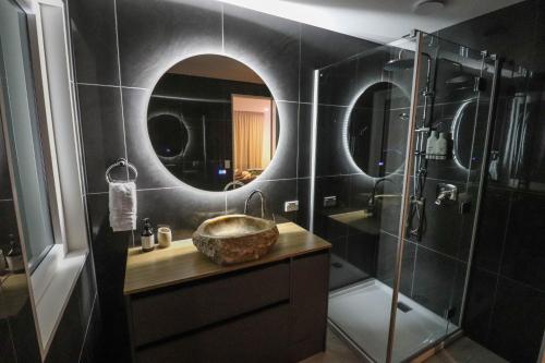 a bathroom with a sink and a shower with a mirror at View With A Room NZ - Boutique Beachfront Accommodation on the Great Coast Road in Runanga