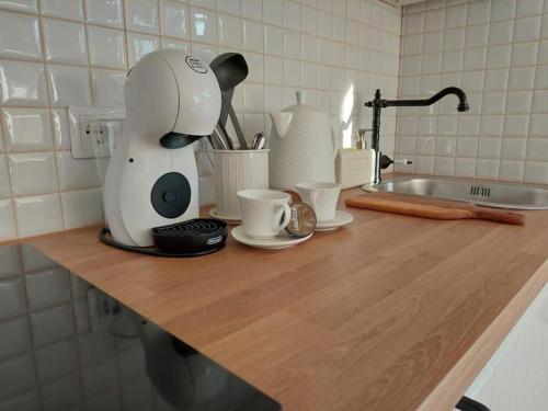 a kitchen counter with a coffee maker and cups on it at Sun coast house in Saulkrasti