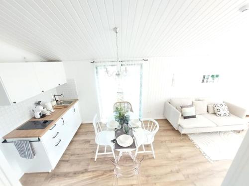 a kitchen and living room with a table and chairs at Sun coast house in Saulkrasti