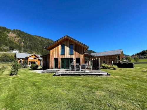 a large wooden house in a field of grass at Chalet Bellevue Murau in Murau