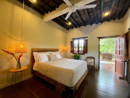 a bedroom with a bed and a table and a window at Mentto Hotel in Guaduas