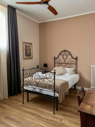 a bedroom with a bed and a ceiling fan at Convento Boutique Hotel in Susa