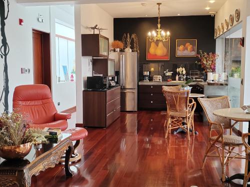a kitchen and living room with a table and chairs at Ana Frank Boutique Hotel in Lima
