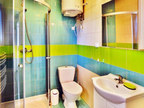 a bathroom with a toilet and a sink and a shower at Two-story holiday house for 5 people, Jaroslawiec in Jarosławiec