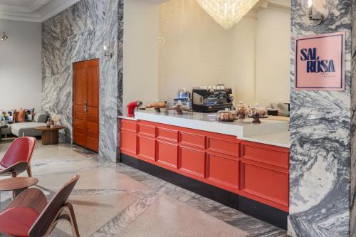 a restaurant with a red and white counter and chairs at Le Meridien Tampa, The Courthouse in Tampa