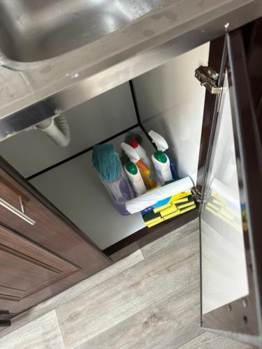 an open drawer in a kitchen under a sink at SG Homes in Abu Dhabi