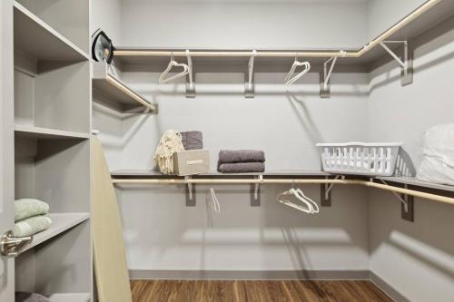 a walk in closet with shelves and towels at Stunning 1BD apt in Fort Worth