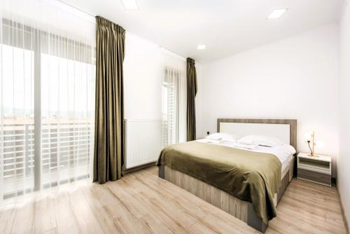 a bedroom with a bed and a large window at Casa Beaumont Cristian in Cristian