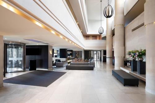 a lobby of a building with couches at Sheraton Stockholm Hotel in Stockholm