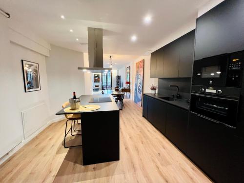 a kitchen with black cabinets and a counter top at ESPOLON LUXURY 10 in Logroño