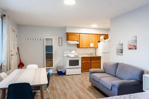 a living room with a couch and a table at Poplars Motel on the lake in Osoyoos
