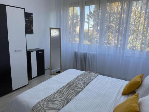 a bedroom with a white bed with a pillow on it at Apartament Bucuresti Bucharest in Bucharest
