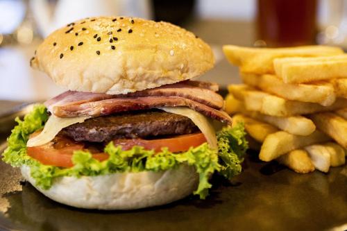 a hamburger and french fries on a plate at City Express Plus by Marriott Cali Colombia in Cali