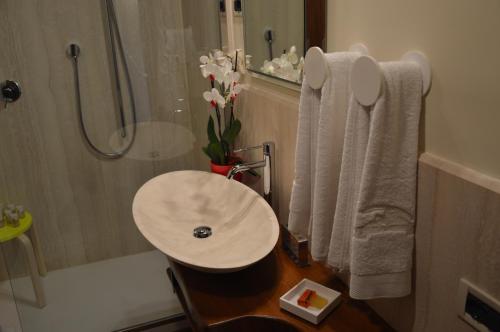 a bathroom with a sink and a shower and a tub at Fattoria Lucciano in Borghetto