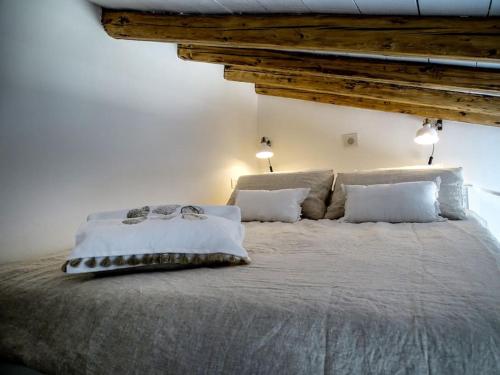 a bedroom with a large bed with white sheets and pillows at Casa Vela in Cefalù