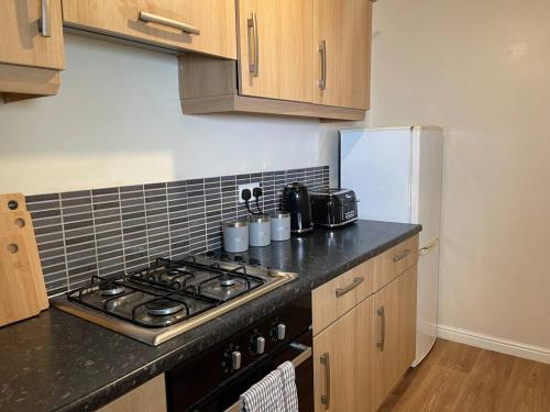 a kitchen with a stove and a refrigerator at Entire 2BR Cosy Home Thornaby in Thornaby on Tees