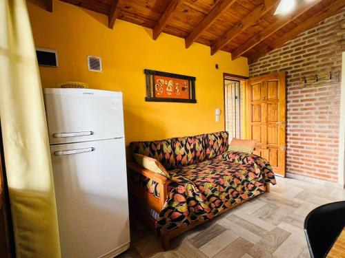 a living room with a couch and a refrigerator at Mirador del Valle in Mina Clavero