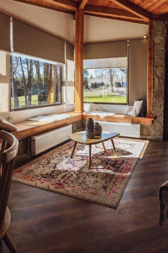 a living room with a table and a couch at PURA Hotel in Coihaique