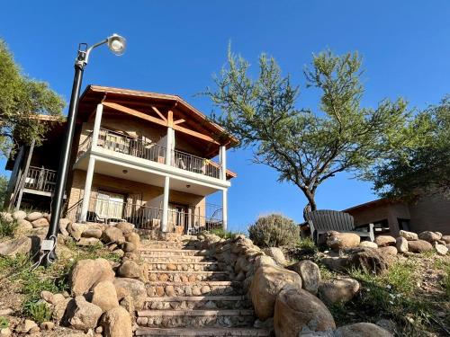 a building with a staircase in front of a house at Mirador del Valle in Mina Clavero