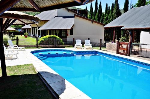 a swimming pool in the backyard of a house at Los Alamos in Villa General Belgrano