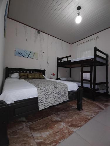 a bedroom with two bunk beds in a room at Salamandra Costa Rica in Jiménez