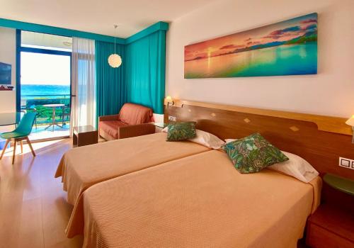 a hotel room with two beds and a view of the ocean at Hotel Blaucel in Blanes