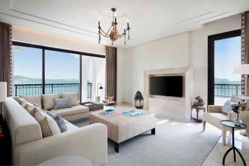 a living room with a couch and a fireplace at The St. Regis La Bahia Blanca Resort - Tamuda Bay in Fnidek