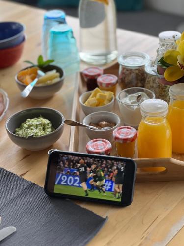 a table with food and a cell phone on it at Tutukaka Sunrise in Tutukaka