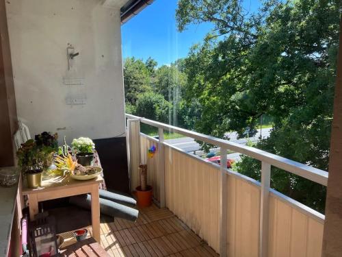 a balcony with a table and a view of trees at Private room in a shared apartment in Västerås