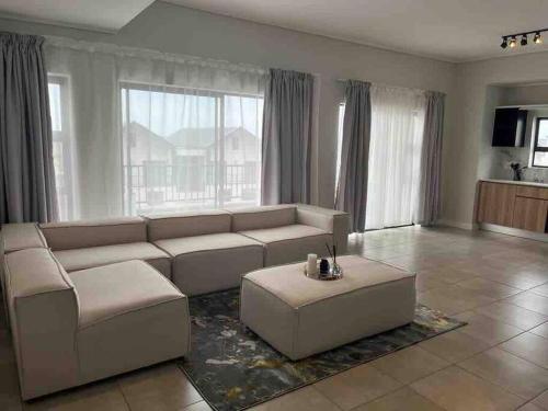 a living room with a couch and a coffee table at 3 Elizabeth Place Luxury Penthouse - Beautiful self catering 2 bedroom unit next to the Lagoon with free WiFi - swimming pool gym and restaurant - Perfect for a small family in Midrand