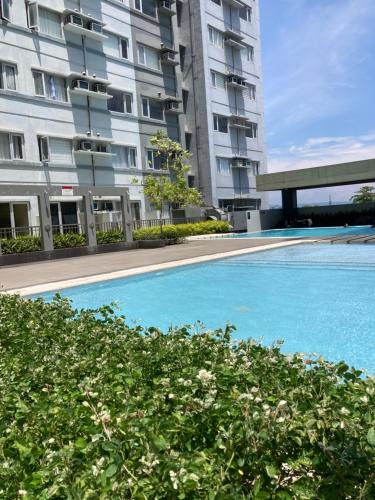 a large swimming pool in front of a building at Avida Studio unit in Davao City