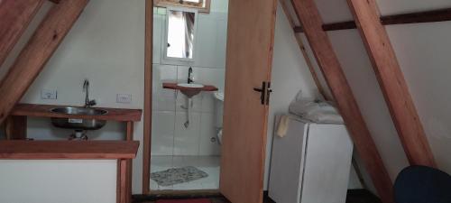 a small bathroom with a sink and a sink at Recanto agape chalés e cabana in Rosas