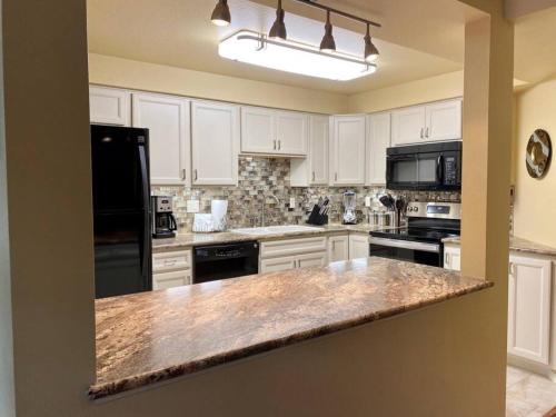 a kitchen with white cabinets and a granite counter top at Hidden Gem in SE Boise with hot tub and wood burning fireplace in Boise