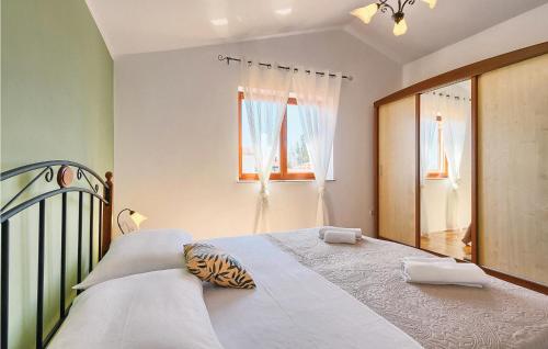 a bedroom with a large bed and a window at Beautiful Home In Fazana With Kitchen in Fažana