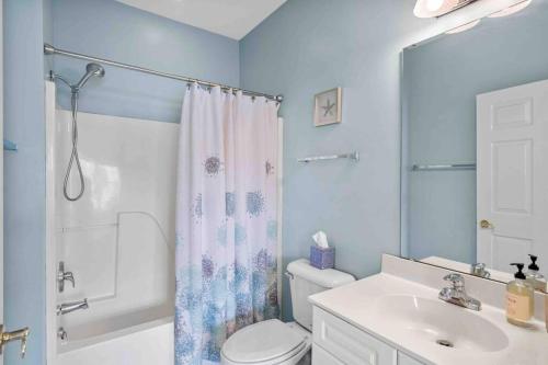 a bathroom with a toilet and a sink and a shower at 2BR 2BA Waterfront Villa 10min to Beach and Market Common in Myrtle Beach