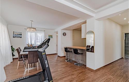 a room with a treadmill and a kitchen with a table at Nice Apartment In Zuljana With Wi-fi in Žuljana