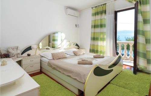 a bedroom with a bed with a large window at Beautiful Home In Omis With House Sea View in Zakučac