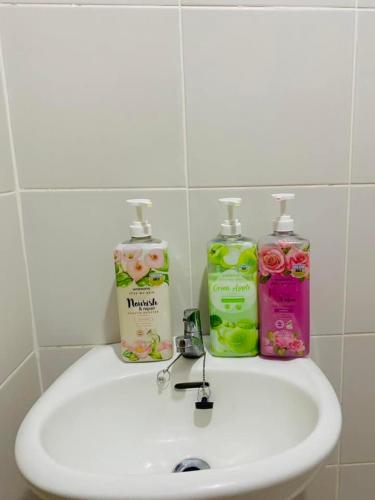a bathroom sink with two bottles of detergent at 8 Spatial Condo in Davao City
