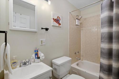a bathroom with a toilet and a sink and a shower at Modern 2 Bdrm 10 Mins Metro To City Center in Philadelphia